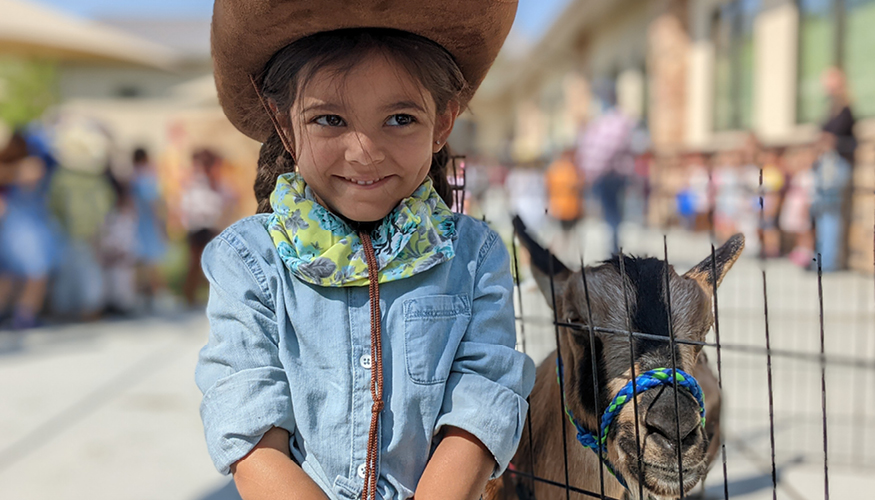 Three happy Challenger kindergarteners dressed up for Western Days