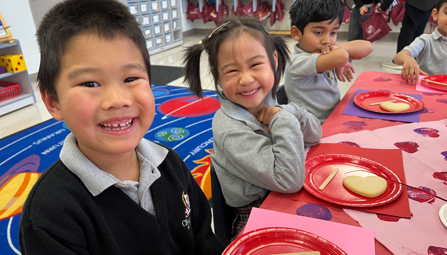 Two smiling Challenger students enjoying Valentine’s Day celebrations