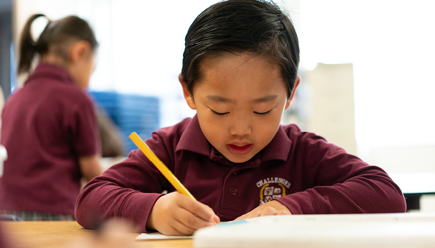 Challenger preschool student practicing penmanship