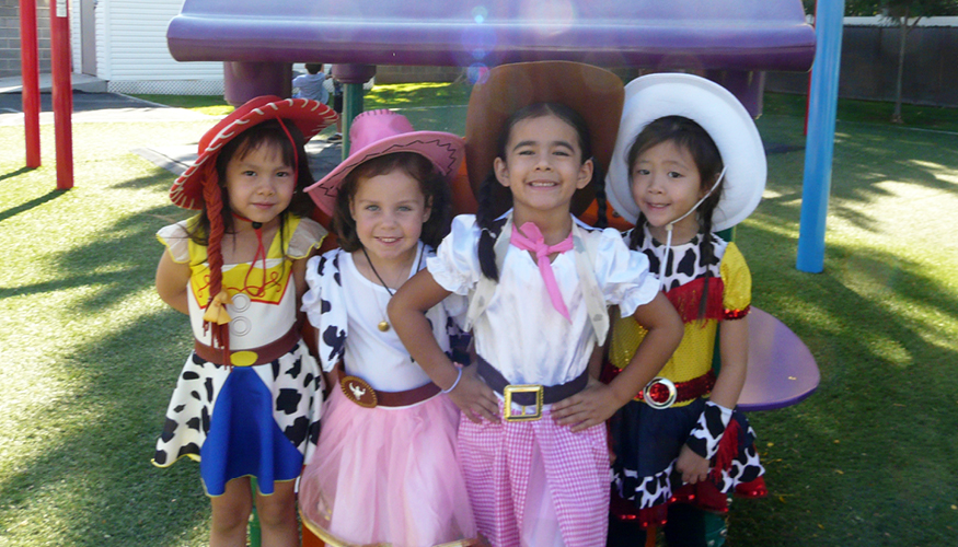 Four happy Challenger students dressed up for 西方天